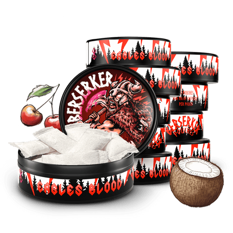 10 can stack of Berserker Eagles Blood caffeine pouches with cherries in the background and a coconut in the foreground implying it's 'Cherry Coconut' flavor. The front can is open showing the white discreet energy pouches inside.