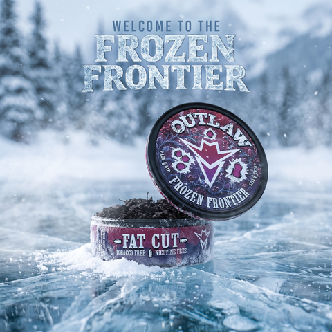A tin of Outlaw 'Frozen Frontier' tobacco and nicotine free mix sits open on a snowy icy surface with a blurred winter forest background. The product packaging features a dark purple and red design with white text.